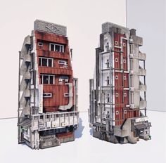 two tall buildings made out of different materials