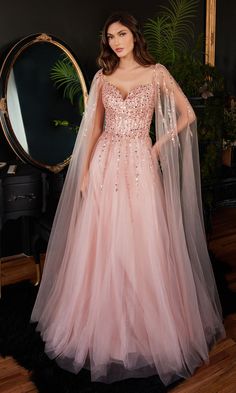 Completely jaw-dropping, this long beaded prom dress is ready to wow the crowd. So stunning for prom, galas, and other red-carpet events, this long a-line formal dress features a beaded bodice that wraps around to the back and off-the-shoulder beaded sheer cape sleeves that flow to the floor like a dramatic train. In misses and plus sizes, this gorgeous long sweetheart evening gown has matching beads trailing down the front of the multi-layered shimmer-tulle skirt that flows to the floor in an a Boho Dress Formal, Details Drawing, Gown With Cape, Sleeve Prom Dress, Evening Gala, Intricate Beading, Cinderella Divine, Strapless Prom Dress, Pink Gown