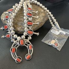 Masha Indian Native American Jewelry -On Route 66 - Albuquerque, New Mexico U.S.A Item Specifics   * Stone : Coral * Type : Necklace * SKU : 16118 * Color : Red * Theme : Ethnic * Closure : Hook * Antique : Yes * Metal : Sterling Silver * Metal Purity : 925 * Country : USA * Size : 17" * Artisans Phil and Lenora Garcia   Genuine Sterling Silver Jewelry This beautiful Necklace is made from all 925 Sterling Silver Components and Findings.  These necklaces are meticulously handmade and assembled by the artist creating the perfect balance of fall, color and shine. Necklaces are a must have for any collection, whether you are just starting out or are a serious collector you will not be disappointed with this work of art. These necklaces have excellent fall and can even be stacked with others, f Western Style Red Jewelry As Gift, Silver Squash Blossom Necklace, Red Theme, New Mexico Usa, Albuquerque New Mexico, Native American Artists, Squash Blossom Necklace, Squash Blossom, Fall Color