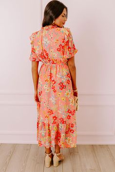 - Drape yourself in petals and twirl in the sun with this airy dress! - Chiffon material with a colorful abstract floral print - A built-in lining that ends above the ruffled hemline - A ruffled v-cut neckline with a tie detail - Short, loose ruffled sleeves - Pleated detail at the bodice - An elastic waistline - A flowy yet flattering silhouette that ends in a ruffled maxi length hemline Pink Maxi Dress With Ruffle Hem For Vacation, Breezy Floral Print Maxi Dress For Garden Party, Pink Tiered Floral Dress With Ruffles, Summer Floral Dress With Ruffle Hem For Vacation, Multicolor Flowy Floral Dress For Garden Party, Flowy Multicolor Floral Dress For Garden Party, Pink Ruffle Hem Maxi Sundress, Coral Dress For Spring Brunch, Flowy Floral Maxi Dress With Ruffle Hem