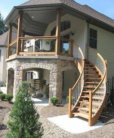 a large house with stairs leading up to the front door and second story balcony area