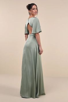 the back of a woman wearing a green dress