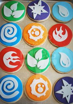 six decorated cookies with different designs on top of a cookie sheet in the shape of fire and water symbols