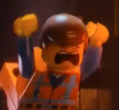 the lego movie character is wearing an orange vest and holding two yellow lollipops