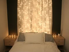 there is a bed that has lights on the wall behind it