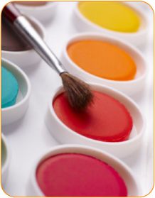 an artist's palette with paint and a brush