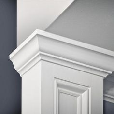 the corner of a white door frame against a gray wall