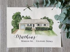 a watercolor painting of a house with the words mathus on it