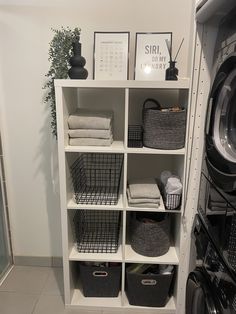 a washer and dryer sitting next to each other in front of a white shelf