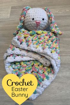 a crocheted bunny wrapped in a blanket with the words crochet easter bunny on it