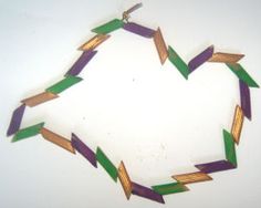 a necklace made out of green and purple strips