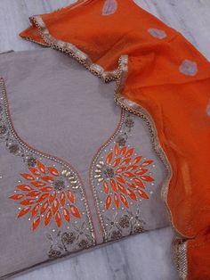 Item Overview ATHARVA Hand Embroidery Salwar Kameez w/Beautiful Embroidered Neck in Grey/Orange Dupatta/Customized Stitching/Bridal Trousseau/ Dno. CH1297 Fabric: * Shirt: Chanderi Silk - 2.5 Mts - Grey - Neck Embroidery * Dupatta: Chiffon Chinnon 2.5 Mts - Orange * Bottom Santoon Silk Salwar 2.5 Mts. Excusive Hand Embroidered Party Wear Punjabi Suit. Customization: * Fabrics Customization: Designs Can be made in different Fabrics. * Color Customization: Designs Can be made in different Colors. Festive Orange Embroidered Lehenga, Orange Embroidered Chanderi Lehenga, Orange Chanderi Lehenga With Resham Embroidery, Bollywood Style Embroidered Orange Lehenga, Orange Embroidered Dola Silk Lehenga, Orange Dola Silk Sets With Resham Embroidery, Fitted Embroidered Orange Anarkali Set, Orange Sets With Resham Embroidery In Traditional Drape, Orange Resham Embroidery Sets For Navratri