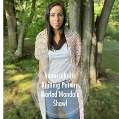 a woman standing in front of trees wearing a white shirt and blue jeans with the words knitting pattern, married mandala shawl