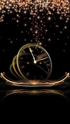 a clock that is sitting in the middle of some gold sparkles on a black background