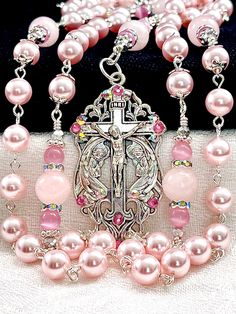 "Magnificent 8mm Rosaline Austrian crystal pearl rosary made with the finest quality satin smooth European pearls, crystals, 10mm Rose Quartz gemstones, Cat's Eye gemstones, and silver plated embellishments. This rosary is very dressy and formal, yet perfect for every Sacramental occasion, First Communion, Wedding, Confirmation, or that special gift that says, \"I'm thinking of you\". If you're wanting Swarovski pearls, I think you'll find the quality of these Rosaline pearls to match them in we Spiritual Crucifix Jewelry For Wedding, Elegant Pink Rosary Bracelet For Wedding, Elegant Pink Wedding Rosary Bracelet, Wedding Rosary With Crucifix Spiritual Style, Handmade Silver Wedding Rosary, Spiritual Wedding Rosary With Crucifix, Spiritual Beaded Rosary Bracelet For Wedding, Spiritual Wedding Jewelry With 8mm Beads, Spiritual 8mm Beads Jewelry For Wedding