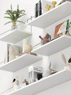 three white shelves filled with books and stuffed animals