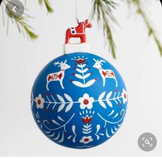 an ornament hanging from a christmas tree with reindeers painted on the ornaments