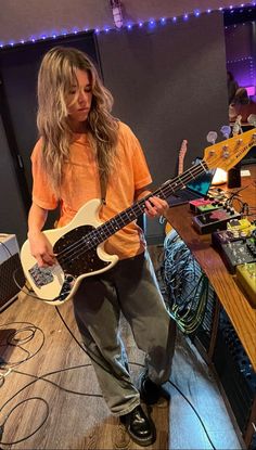 a young man is playing an electric guitar