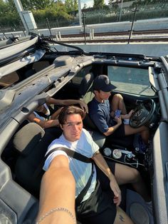 three people sitting in the driver's seat of a boat