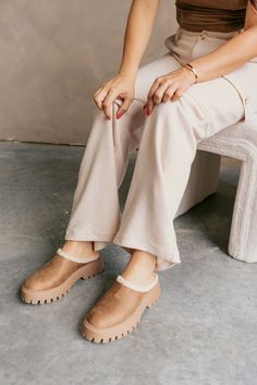 The Ladie Tan Slipper Clog—a cozy yet stylish staple for your footwear collection. This clog showcases a soft tan suede upper, providing a warm and natural finish to your look. Designed with comfort in mind, it features a plush sherpa lining that offers a snug, cushioned feel for all-day wear. The lug platform sole adds a bold touch, elevating your style while offering extra grip and support. With its effortless slide-on design and round toe for a relaxed fit, this clog is perfect for cozy days Faux Leather Purse, Wooden Clogs, White Bodycon Dress, Travel Dress, Wooden Shoes, Basic Design, Footwear Collection, Jumpsuit Shorts Rompers, Maxi Dresses Casual