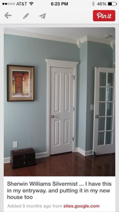 an image of a room with blue walls and white trim on the door, along with a brown trunk