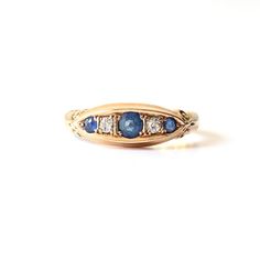 A classic antique Diamond & Sapphire boat ring. Weighing an impressive 4.6grams of 18ct gold; this ring has been exceptionally well made with no expense spared. Set with three inky blue Sapphires and two splendid Diamonds in a classic boat style setting.  The gems are of the finest quality, the Diamonds have a brilliant fire which  have a beautiful flash when they catch the light. An eye catching antique ring; which sits flush to the finger making it perfect for everyday wear. This ring comes pr Heirloom Sapphire Rings For Collectibles, Heirloom Sapphire Rings Collectible, Heirloom Sapphire Rings For Collectors, Heirloom Style Sapphire Ring Stamped 14k, Heirloom Sapphire Ring Stamped 14k, Heirloom Sapphire Ring For Promise, Heirloom Sapphire Collectible Rings, Heirloom Blue Engraved Ring, Blue Heirloom Engraved Ring