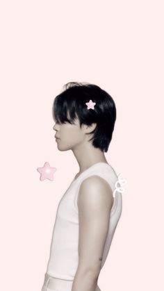 a woman with short black hair wearing a white top and pink stars in her hair