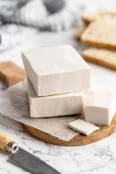 several pieces of cheese are on a cutting board