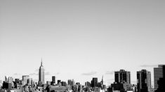 a black and white photo of a city skyline with the empire building in the background