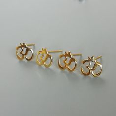 A PAIR of OM ear studs made of sterling silver and dipped in gold. Dimensions: 8 x 9 mm Weight: 0.72gm Price listed is for ONE PAIR These are made of 925 hypoallergenic sterling silver plated in gold Most of my pieces come with a 925 stamp. Can be packaged in a gift box. I can include a personal message from you if needed You are welcome to contact me at... bhavnakwintra1956@gmail.com For more beautiful pieces from my shop, please browse 👇 TOE RINGS: https://www.etsy.com/your/shops/TheSilverGam Nickel-free Gold Cartilage Earrings Gift, Gold Sterling Silver Cartilage Earrings Gift, Gold Sterling Silver Piercings As A Gift, Gold Spiritual Plug Earrings, Handmade Gold Sterling Silver Cartilage Earrings, Handmade Gold Cartilage Earrings In Sterling Silver, Handmade Gold Cartilage Earrings As Gift, Handmade Gold Cartilage Earrings For Gift, Minimalist Handmade Gold Cartilage Earrings