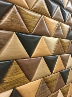 a wooden wall with many different colors and shapes on it's sides, including wood