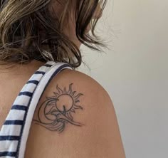 a woman with a sun tattoo on her shoulder