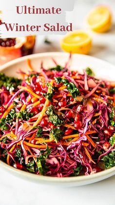 a white bowl filled with red cabbage and kale salad next to sliced lemons