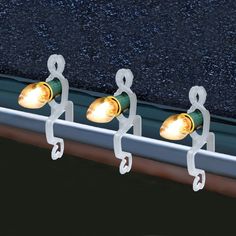 three lights that are attached to a rail