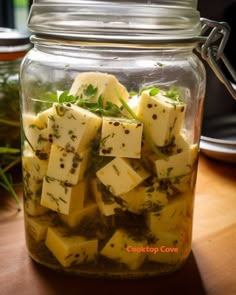 a glass jar filled with food sitting on top of a wooden table