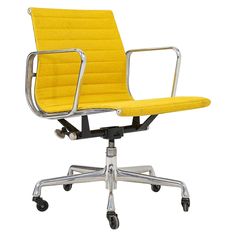 a yellow office chair with chrome frame and casteor wheels on an isolated white background