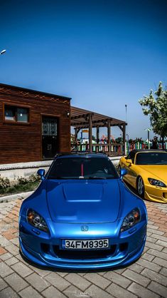 two cars parked next to each other in front of a building