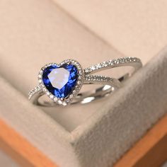 This ring features a 8 mm heart cut lab sapphire,and sterling silver finished with rhodium. Customization is available. It is made by hand, and it will take about 7 days to finish the ring after your payment is completed. Main stone: lab sapphire Main stone weight: Approx 2.59 ct Metal type: sterling silver finished with rhodium Accent stone: cz Customization is available, I also can make it with 14k solid gold (white or yellow or rose) and diamond accent stone, just feel free to contact me. Any Sapphire Diamond Wedding Band, Mata Biru, Cute Promise Rings, Sapphire Wedding Rings, Filigree Jewelry, Sapphire Wedding, Heart Shaped Rings, Silver Wedding Rings, Ring Blue