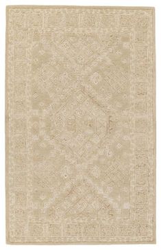 a beige rug with an intricate design on the front and back side, in neutral tones