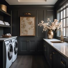 a washer and dryer in a room with black walls