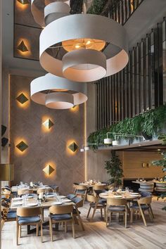 a restaurant with circular lights and wooden tables