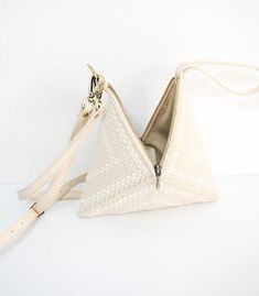 The Pusô Pyramid Handbag is a statement clutch that packs a punch. Compact and functional, the Pusô easily carries all your essentials and adds the perfect touch of Filipiniana elegance to a wedding or special occasion! It also features an innovative collapsible design, so you can store it with ease between functions. Handcrafted by community artisans in Metro Manila, the Pusô is woven from upcycled, overstock fabrics interlaced with elegant grosgrain ribbon inserts and a genuine cowhide leather Statement Clutch, Gel Pack, Wedding Purse, Wedding Clutch, Grosgrain Ribbon, You Bag, Cowhide Leather, Leather Straps, Special Occasion