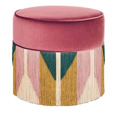 a pink ottoman with tassels on it