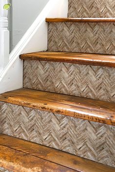 some wooden steps with white handrails next to a stair case in a house