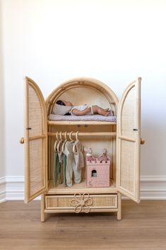 a baby laying on top of a bed next to an open closet