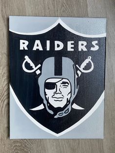 a close up of a metal sign with a football helmet on it's face