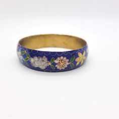 Pretty vintage cloisonne bangle bracelet. The bracelet features a lovely dark blue enamel with a floral design.   Unknown maker. Not marked. c 1970s Condition is excellent.  There are no dents or dings.  No chips or cracks.  No repairs.  No corrosion.  Ready to wear. The bracelet measures Pretty Rings, Bangle Bracelets, Floral Design, Jewelry Bracelets, Bangles, Bracelet, Ready To Wear, Floral, Blue