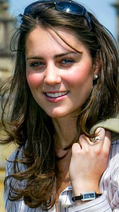 a woman wearing sunglasses and smiling for the camera