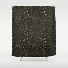 a black shower curtain with flowers and leaves on the outside, in front of a white background