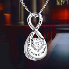 The Infinity Urn Necklace is a poignant symbol of eternal love and dedication. Featuring an infinity symbol, this necklace is a heartfelt way to honor and remember your loved ones. Engraved with the touching message, "No longer by my side, but forever in my heart," it provides comfort by keeping your dear ones close to your heart. Cremation Jewelry: This heart-shaped small urn is crafted from high-quality 925 sterling silver, ensuring it is hypoallergenic, tarnish-resistant, and free from nickel Meaningful Silver Infinity Jewelry, Meaningful Infinity Jewelry For Anniversary, Inspirational Silver Jewelry For Anniversary, Infinity Engraved Necklaces For Anniversary, Engraved Infinity Necklace For Anniversary, Anniversary Engraved Infinity Necklace, Forever In My Heart, Small Urns, Urn Necklace